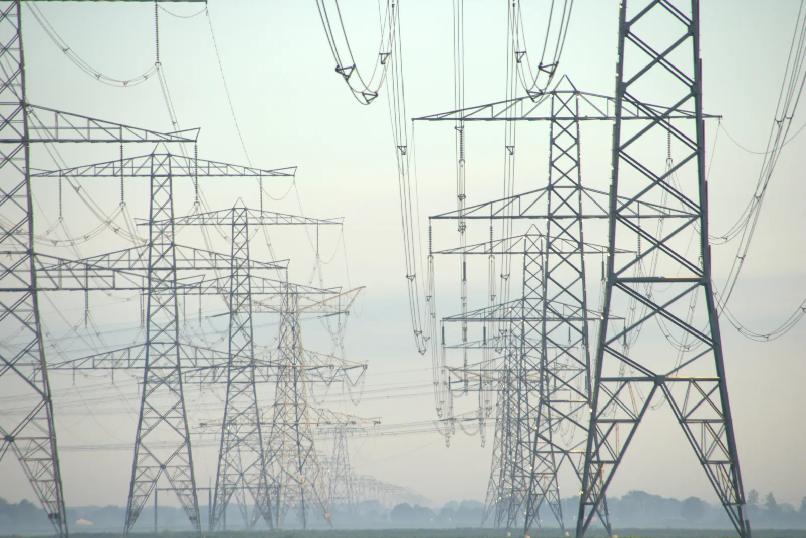 High-voltage transmission lines at dawn